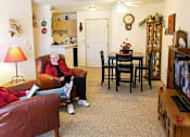 Thumbnail 14 of 14 - two people sitting in a living room watching tv