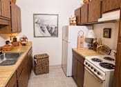 Thumbnail 11 of 16 - a kitchen with a stove refrigerator and a sink