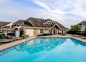 Thumbnail 18 of 21 - A swimming pool in front of a row of houses.