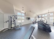 Thumbnail 21 of 21 - A gym with a row of exercise bikes and a treadmill.