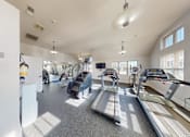 Thumbnail 19 of 21 - A spacious gym with treadmills and exercise equipment.
