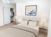 Thumbnail 12 of 28 - a bedroom with a bed and a painting on the wall