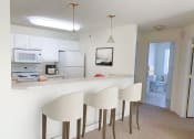 Thumbnail 9 of 28 - a kitchen with white cabinets and a counter top