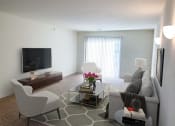 Thumbnail 10 of 28 - a living room with white furniture and a television