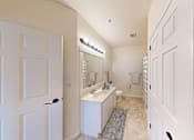 Thumbnail 19 of 59 - A white bathroom with a sink, mirror, and toilet.