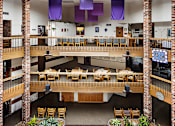 Thumbnail 4 of 16 - a view of therium of a building with tables and chairs