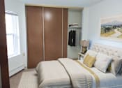 Thumbnail 9 of 12 - a bedroom with a bed and a closet