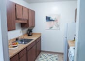 Thumbnail 8 of 12 - a kitchen with wooden cabinets and a sink and a refrigerator