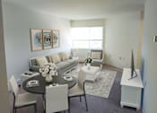 Thumbnail 6 of 12 - a living room with a couch and a table