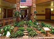 Thumbnail 5 of 16 - a courtyard with plants and a flag in a lobby