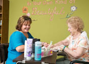 Thumbnail 12 of 14 - a woman sitting at a table talking to a patient