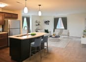 Thumbnail 3 of 28 - a kitchen and living room with an island in the middle of it