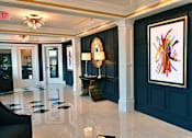 Thumbnail 14 of 25 - a lobby with blue walls and a painting on the wall