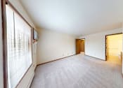 Thumbnail 15 of 50 - A room with a carpeted floor and a doorway leading to another room.