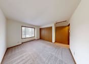 Thumbnail 17 of 50 - A room with a carpeted floor and a window.