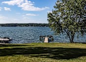Thumbnail 36 of 50 - a dock on a lake next to a tree