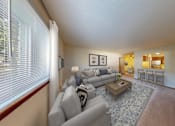 Thumbnail 43 of 50 - A living room with a grey couch and a coffee table.
