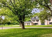 Thumbnail 30 of 50 - a house on the side of a field with trees