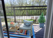 Thumbnail 14 of 64 - a balcony with a table and chairs and a tree