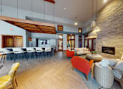 Thumbnail 47 of 64 - A modern living room with a stone fireplace and a dining area.