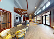 Thumbnail 64 of 64 - A long wooden table with yellow chairs is in a room with a lot of windows.