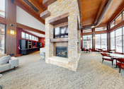 Thumbnail 54 of 64 - A large stone fireplace is in the middle of a spacious living room.