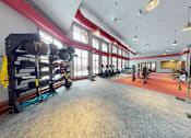 Thumbnail 57 of 64 - A gym with a variety of equipment including weights and exercise machines.