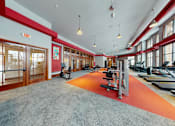 Thumbnail 51 of 64 - A gym with a row of treadmills and exercise bikes.