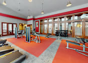 Thumbnail 56 of 64 - A gym with treadmills, weights, and exercise equipment.