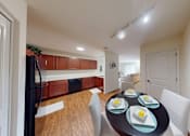 Thumbnail 53 of 65 - A dining table with four place settings is in the middle of a room.