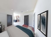 Thumbnail 31 of 64 - a bedroom with a bed and a door to a bathroom