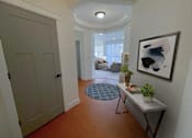 Thumbnail 21 of 53 - a hallway with a white door and a painting on the wall