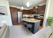 Thumbnail 14 of 53 - a kitchen with a center island with three stools