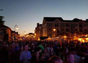 Thumbnail 4 of 10 - a crowd of people standing on a street at night