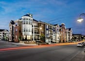 Thumbnail 19 of 53 - an apartment building on a city street at night