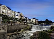 Thumbnail 2 of 53 - a waterfall in front of a building at night