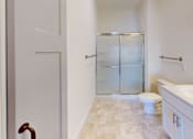 Thumbnail 37 of 53 - A bathroom with a toilet, sink, and shower.