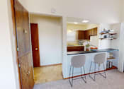 Thumbnail 2 of 4 - a kitchen with a counter and two stools