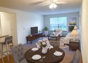 Thumbnail 16 of 22 - a living room and dining room with a table
