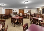 Thumbnail 20 of 22 - a dining room with tables and chairs and a fireplace