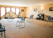 Thumbnail 8 of 22 - a music room with chairs and a piano and a tripod