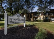 Thumbnail 12 of 21 - a sign that says sunnyside in front of a house