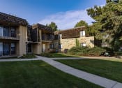 Thumbnail 8 of 21 - a view of two apartment buildings with grass and a sidewalk