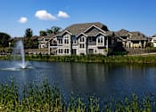 Thumbnail 17 of 53 - a pond with a fountain in front of a house