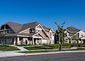 Thumbnail 37 of 53 - a group of houses on a street with a blue sky