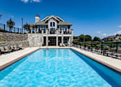 Thumbnail 20 of 53 - a pool with a house in the background