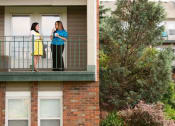 Thumbnail 24 of 28 - two women standing on a balcony talking to each other