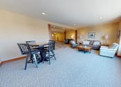 Thumbnail 26 of 53 - A living room with a dining table and chairs.