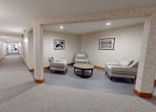Thumbnail 27 of 53 - A hallway with two chairs and two pictures on the wall.