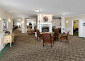 Thumbnail 9 of 14 - a large living room with a fireplace and a dining table